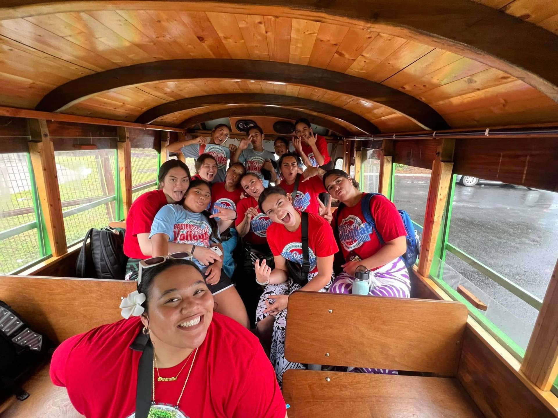 American Samoa beach volleyball team together on a tour bus